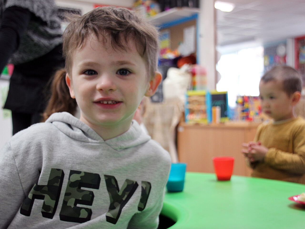 Boy in front of green table
